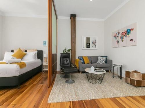 a living room with a bed and a couch at 1BR CBD Escape Near Sky Tower Zodiak Stays in Auckland