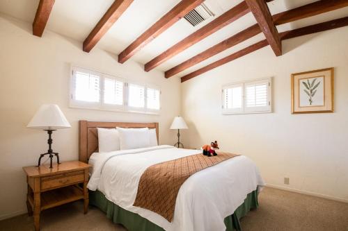 a bedroom with a bed with a teddy bear sitting on it at La Casa Del Zorro Resort & Spa in Borrego Springs