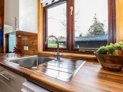 a kitchen with a sink and a window at Latrigg Lodge in Keswick