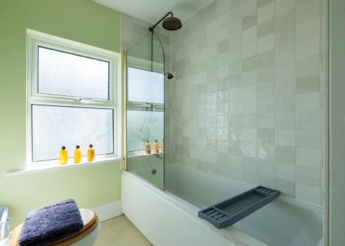 a bathroom with a shower and a bath tub at Lundy House in Port Isaac