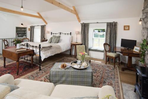 a living room with a bed and a table at Pigeon Loft in Kirk Yetholm