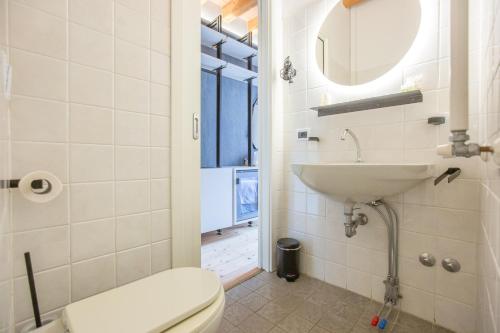 a bathroom with a toilet and a sink at Albergo Del Sole in Varenna