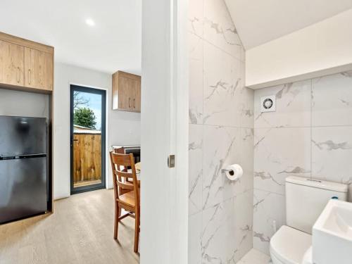 a kitchen with a sink and a toilet in a room at Gorgeous Three Bedroom Home with Free Parking in Auckland