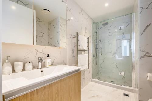 a bathroom with a sink and a shower at Spacious Mount Eden Apartment in Auckland