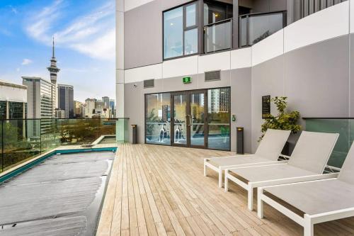 an apartment balcony with a view of the city at Sunny 1BR Retreat in Heart of CBD by Zodiak Stays in Auckland