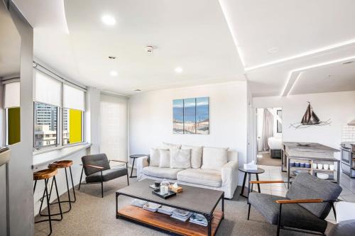 a living room with a couch and a table at Downtown Auckland Bliss - 2BR apt I Zodiak Stays in Auckland