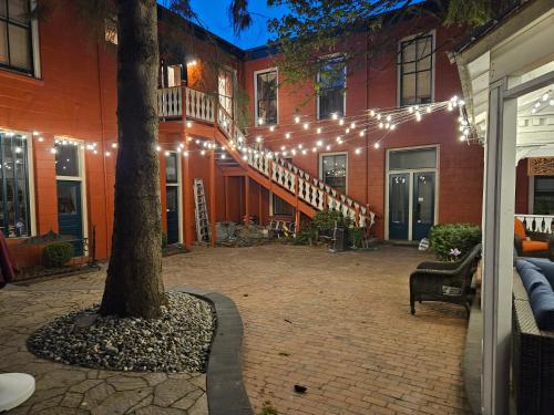 a courtyard with a tree and a staircase with lights at Hotel Planter in La Conner