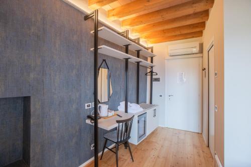 a bathroom with a vanity and a chair in a room at Albergo Del Sole in Varenna