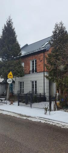 a brick house with a sign in front of it at Cool Apartment in Michałowice