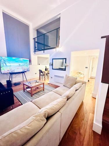 a living room with a couch and a flat screen tv at Exclusive City Apartment - Very Spacious in Sheffield