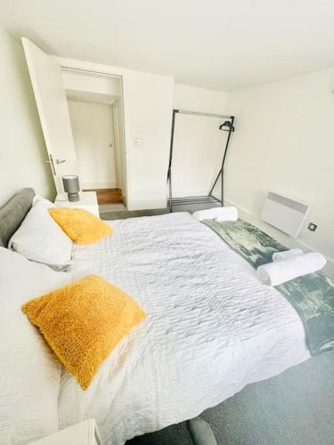 a bedroom with a large white bed with two pillows at Exclusive City Apartment - Very Spacious in Sheffield