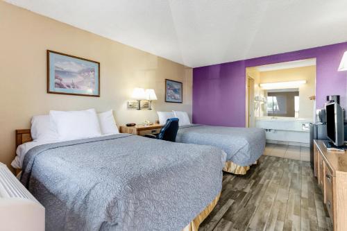 a hotel room with two beds and a television at Knights Inn Madera in Madera