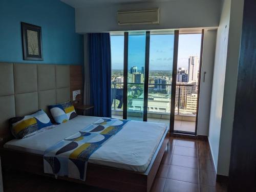een slaapkamer met een bed en uitzicht op de stad bij 4 Bedroom apartment at Uhuru Heights in Dar es Salaam