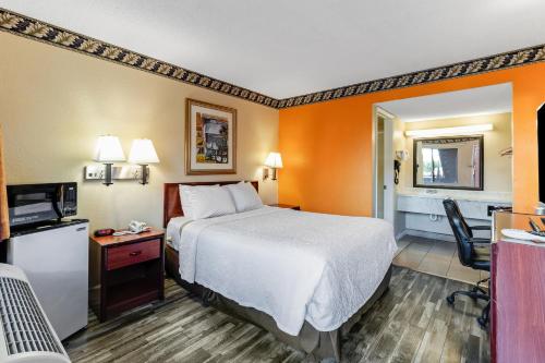 a hotel room with a bed and a desk at Knights Inn Madera in Madera