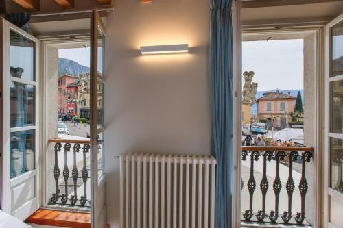 a room with a balcony with a radiator at Albergo Del Sole in Varenna
