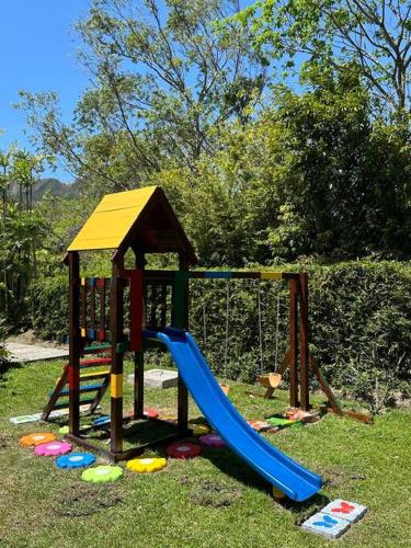 a playground with a slide in the grass at Quinta Las Victorias in Valle de Anton