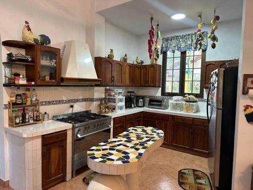 a kitchen with wooden cabinets and a checkered stool at Quinta Las Victorias in Valle de Anton