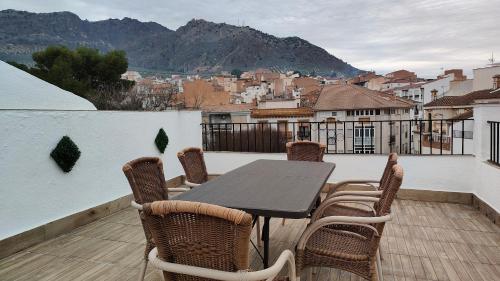 a table and chairs on a balcony with a view at Alojamientos Capri in Quesada