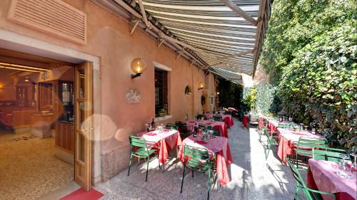 a restaurant with tables and chairs with red tablecloths at Messner Palace in Venice