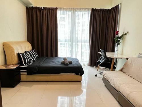 a bedroom with a bed and a couch and a window at Cozy 2BR*Infinity Pool @ Regalia by baitul sakinah in Kuala Lumpur