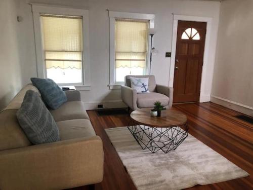 a living room with a couch and a coffee table at LOVELY RENOVATED 2 BEDROOM HOME WITH FREE Parking in Albany