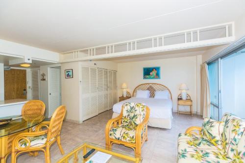 um quarto com uma cama, uma mesa e cadeiras em Ilikai Tower 936 Lagoon View 1BR em Honolulu