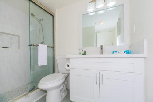 a bathroom with a toilet and a sink and a shower at Ilikai Tower 936 Lagoon View 1BR in Honolulu