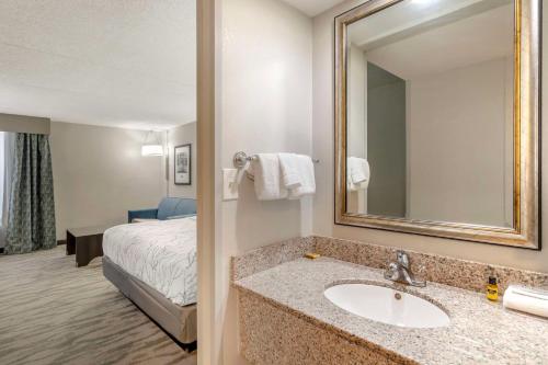 a bathroom with a sink and a bed in a room at Best Western Plus Knoxville Cedar Bluff in Knoxville