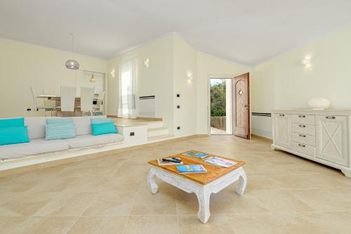 a living room with a couch and a table at Villa Eagle's Nest in Baja Sardinia