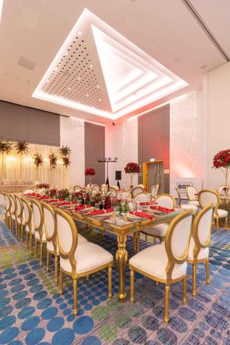a large dining room with a long table and chairs at Radisson RED Dubai Silicon Oasis in Dubai