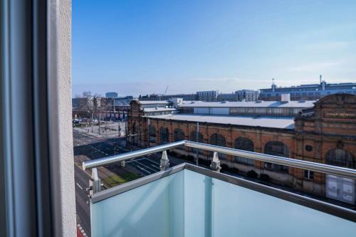 a balcony with a view of a train station at prizeotel Dresden-Mitte in Dresden