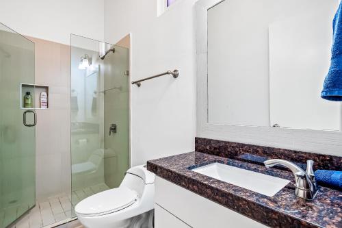 a bathroom with a toilet and a sink and a shower at Casa Capri 39 - Playa Arcangel in Rosarito