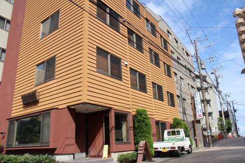 a truck parked in front of a building at Hotel Saika in Fujisawa