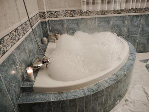 a bath tub filled with water in a bathroom at Son Pujol in Las Ollerías
