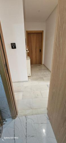 an empty hallway with a tile floor and a door at Cosy & Confort Studio près de l'aéroport in Nouaceur