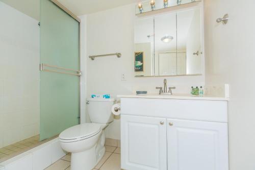 a bathroom with a toilet and a sink and a shower at Ilikai Tower 1744 Yacht Harbor View 2BR in Honolulu