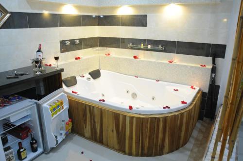 a large bath tub in a kitchen with a refrigerator at Hotel villeta suite in Villeta