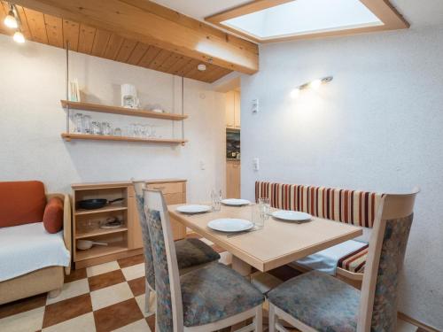 a dining room with a table and chairs and a bed at Jürgen in Zell am See