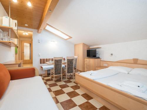 a room with a bed and a kitchen with a table at Jürgen in Zell am See
