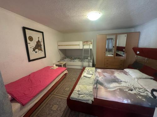 a bedroom with two beds and a bunk bed at Konak in Podgorica