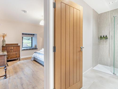 a bathroom with a sliding door and a bedroom at 4 Bed in Newmachar 93914 in Dyce