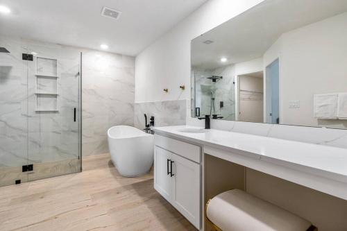 a white bathroom with a sink and a shower at spacious 4-bedroom WITH KING BED in Palm Coast