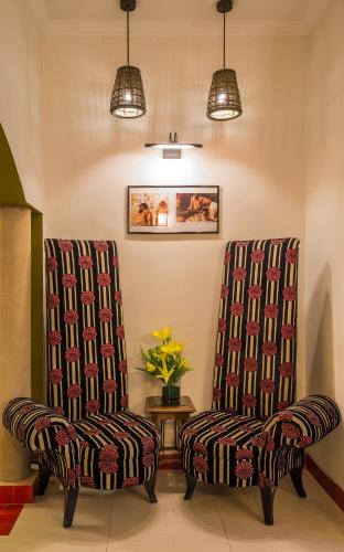 two chairs sitting next to each other in a room at Home@F37 Kailash Colony Metro in New Delhi