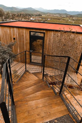 a wooden staircase leading to a building with a door at Bajo Estrellas Hotel Contemporáneo in Valle de Guadalupe