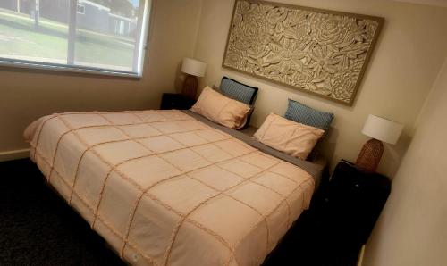 a bedroom with a large bed with two pillows at Echo Beach Tourist Park in Lakes Entrance