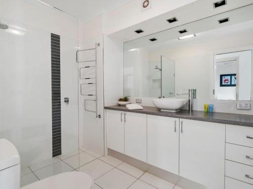 a white bathroom with a sink and a toilet at Yarrawonga Lakeside Apartment 25 in Mulwala