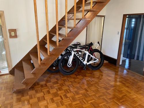 a motorcycle parked under a staircase in a house at Tanonagano Yadokko - Vacation STAY 62252v in Goshogawara