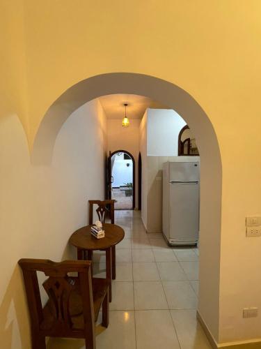 a kitchen with a table and a refrigerator at Red oasis in Dahab