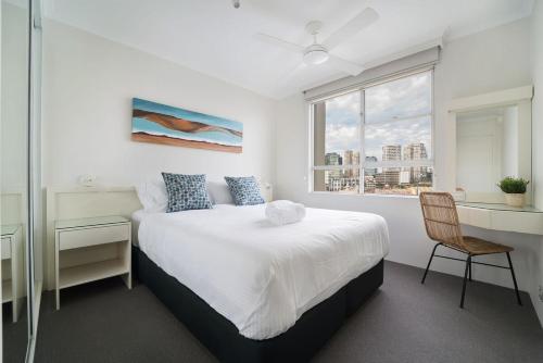 1 dormitorio con cama, escritorio y ventana en Harbourside #49 en Sídney