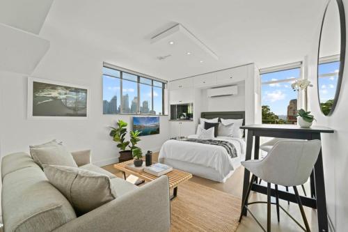 a bedroom and living room with a bed and a table at Modern Potts Point Studio in Sydney